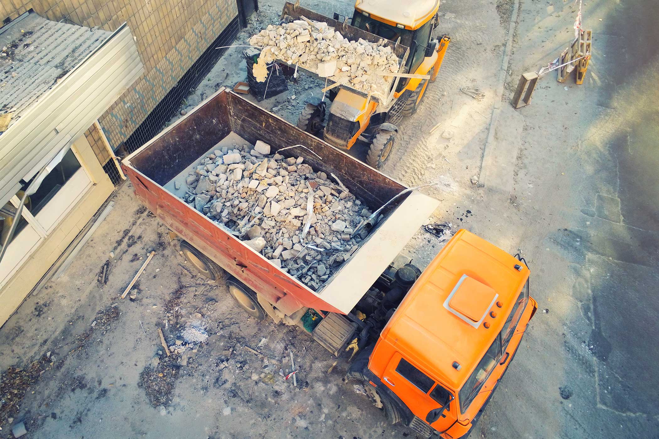 Professional post-construction cleaning crew removing debris from a Dallas construction site